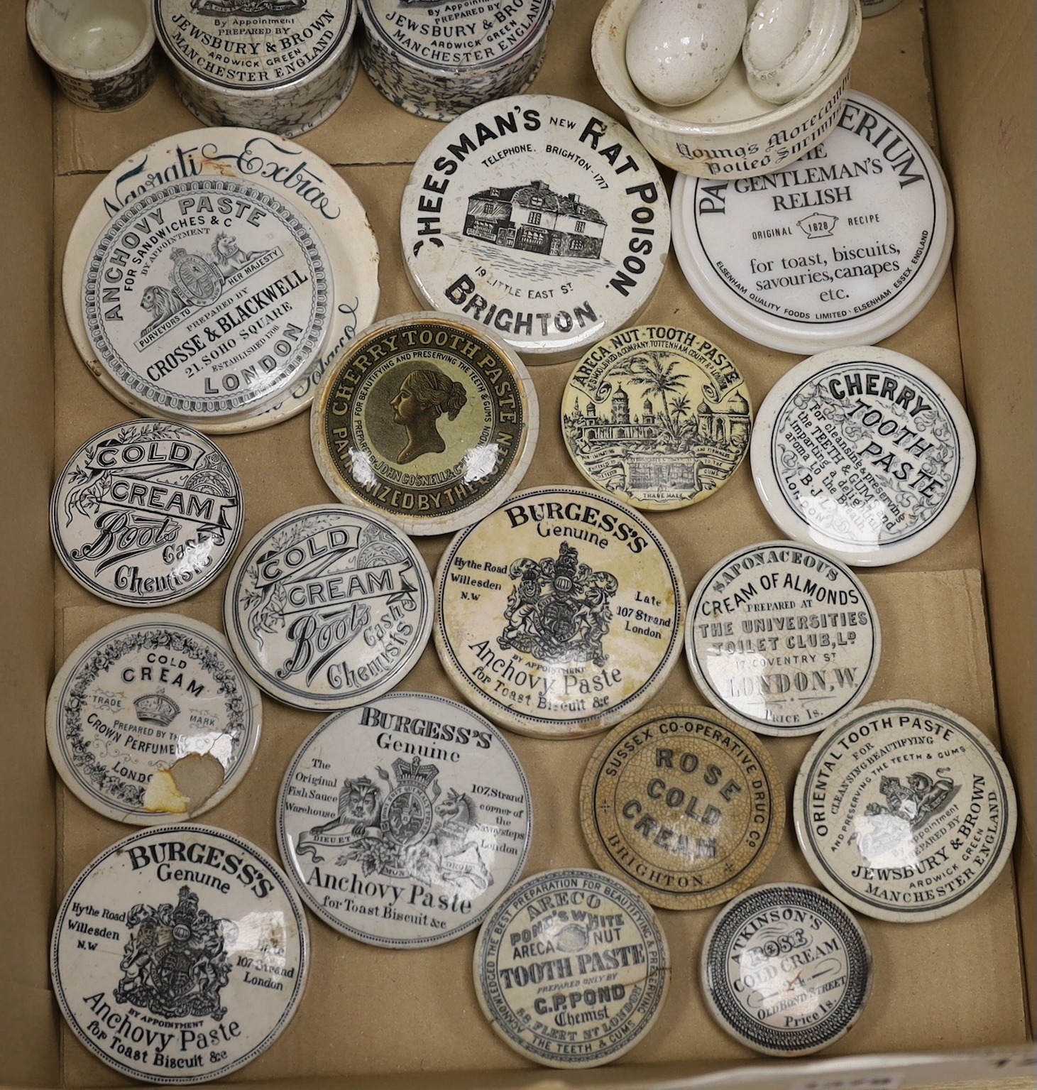 A large collection of anchovy paste toothpaste pot lids and pots together with a Brighton Cheesmans rat poison pot lid